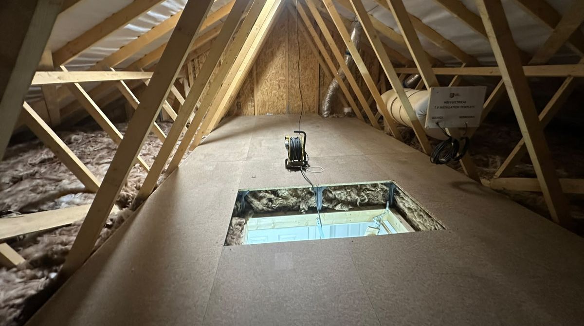 Raised loft boarding around the loft hatch, with insulation underneath